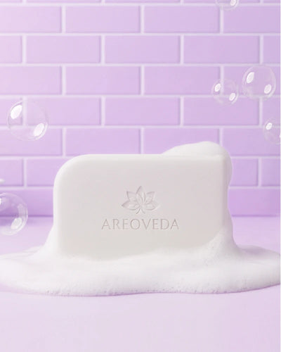Baby soap with 'AreoVeda' branding on a purple tiled background