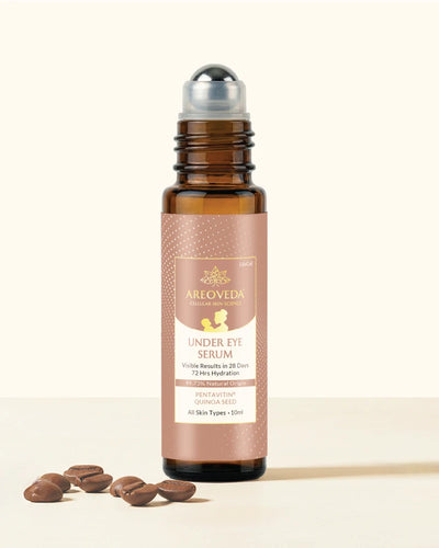 Areoveda under eye serum bottle with cap and droplets on a light background