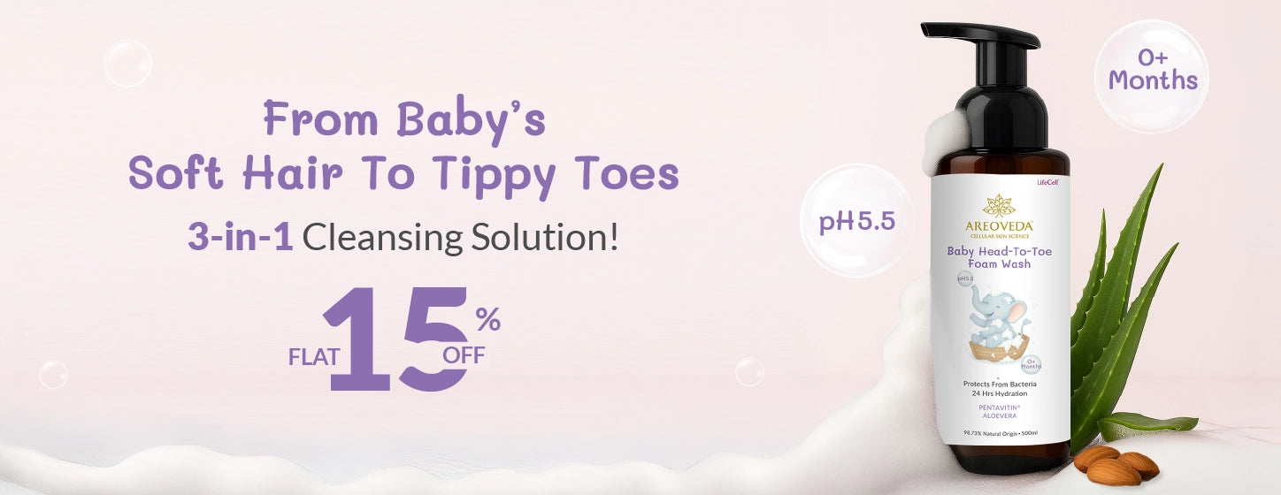 Baby cleansing solution bottle with text on a light pink background